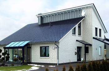 Minimalist white brick facade with contrasting blue roof