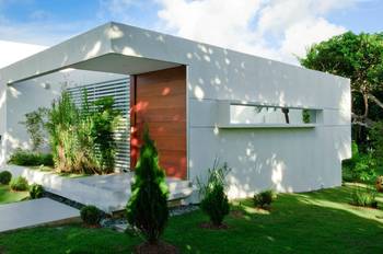 Minimalist white façade with an accented wooden portal