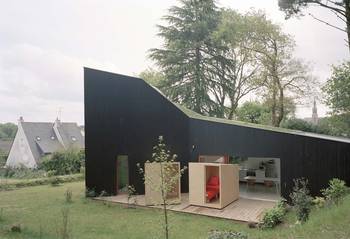 Black minimalist facade with modular extension