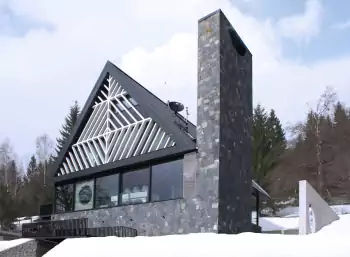Alpine Chalet with Contemporary Façade: A Dialogue of Stone and Geometry