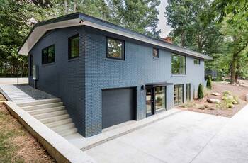 Split-level house with contrasting blue and white facade