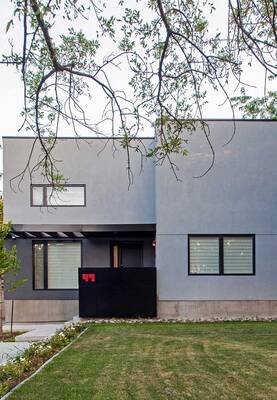 Minimalist gray facade with contrasting entrance group