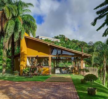 Tropical Yellow Pavilion: Vibrant Facade Embraced by Nature