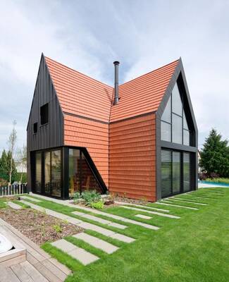 Modern house with terracotta facade and dynamic A-frame roof