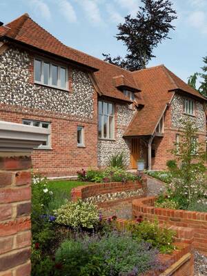 Country house with combined brick and flint facade in English style