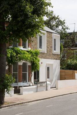 Two-level facade: harmony of brick, stone and greenery in contemporary urban architecture