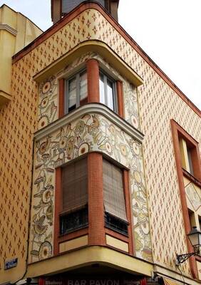 Decorative corner facade with mosaic panels and geometric ornaments