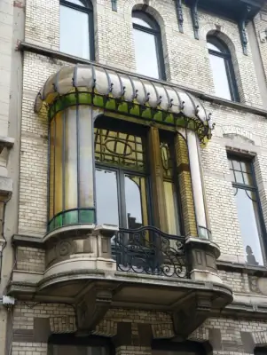 Elegant Art Nouveau Bay Window: Stained Glass Accent on a Historic Facade