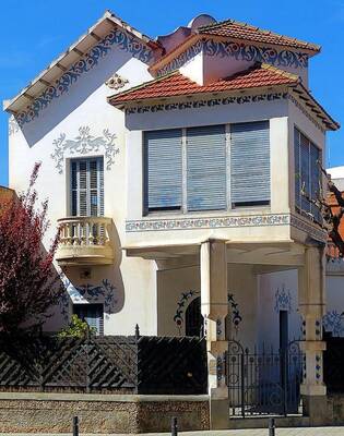 Elegant White Façade with Decorative Mediterranean Motifs