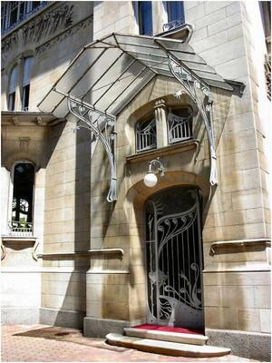 Elegant Art Nouveau Facade with Delicate Metal Canopy and Decorative Entrance Group