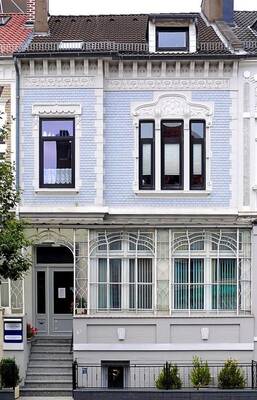 Elegant Blue Art Nouveau Facade with Decorative Elements