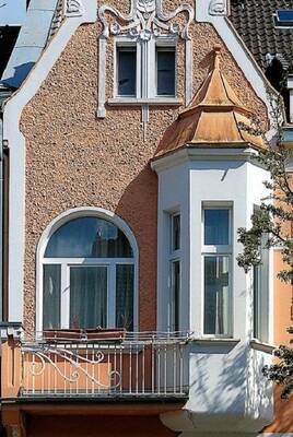 Elegant Art Nouveau: Textured Facade with Bay Window and Copper Roof