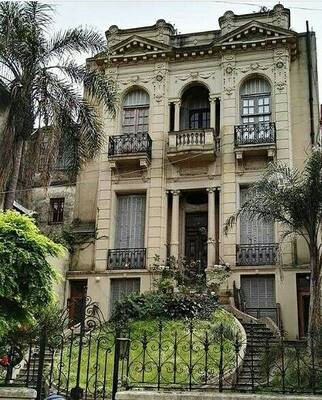 Elegant Neoclassical Façade: Urban Mansion with Rich Ornamentation and Graceful Balconies