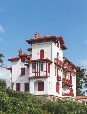 Elegant Basque Villa with Contrasting White and Red Facade