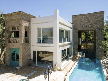 Two-story villa with contrasting facade: blending minimalism and brick texture