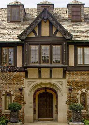 Elegant Tudor Facade with Combination of Brick, Stucco, and Half-Timbering Elements