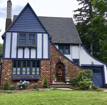 Elegant Tudor Facade with Contrasting Dark Blue Details