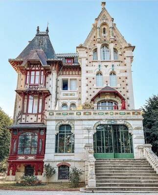 Eclectic Facade of a Historic Mansion: Blend of Neo-Gothic, Art Nouveau, and Half-Timbered Elements