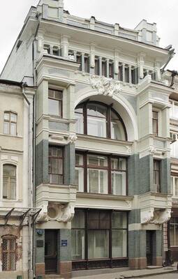 Elegant white Art Nouveau façade with an expressive central arch