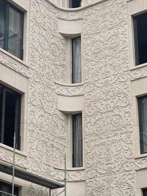 Exquisite carved facade with concave corner surface