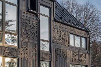 Carved wooden facade with contemporary interpretation of traditional ornaments