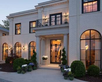 Elegant Snow-White Facade of a Neoclassical Mansion with Arched Windows