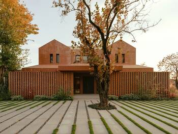 Modern Brick House with Perforated Facade and Geometric Landscape