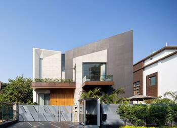 Contemporary Geometric Facade with Contrasting Materials and Integrated Landscaping