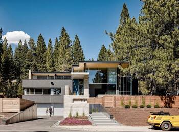 Modern Multi-Level Facade with Panoramic Glazing Surrounded by Pine Forest