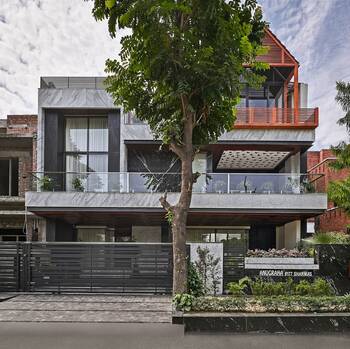 Modern two-story house with contrasting marble facade and wooden pavilion