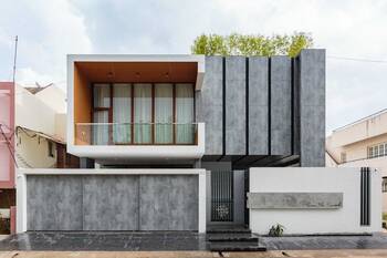 Minimalist Facade with Contrasting Texture: Modern Concrete House with Wooden Accents