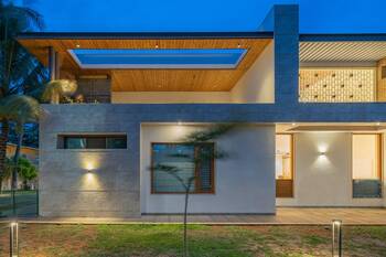 Modern stone and wood façade with open terrace and well-designed lighting system