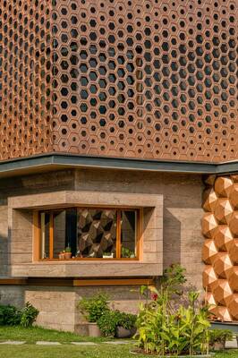 Modern Honeycomb Perforated Facade: Harmony of Copper and Stone