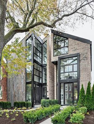 Contemporary dual-material facade with contrasting combination of brick, wood and glass