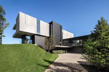 Minimalist Cantilevered Facade: Concrete and Glass Contrast in a Contemporary House