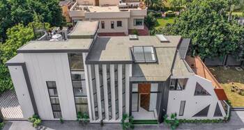 Modern Minimalist Facade with Vertical Louvers and Contrasting Volumes