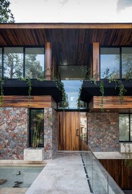 Modern facade with contrasting combination of stone, wood, and glass