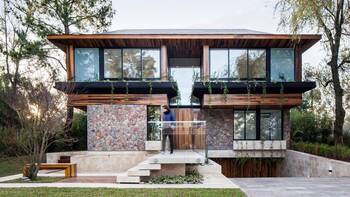 Modern two-story facade with stone and wood combination