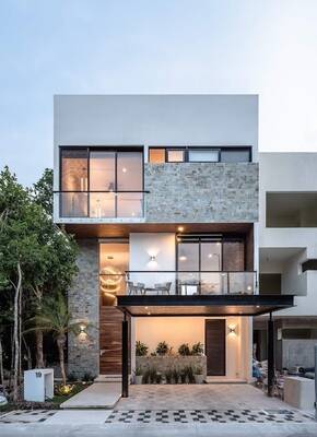 Modern three-story house with contrasting stone and white plaster facade