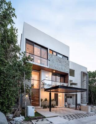 Modern three-story house with minimalist facade of stone, wood and glass