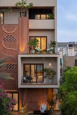 Modern urban residence with decorative terracotta facade and vertical green terraces