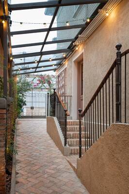 Elegant Facade Passageway with Glass Roof and Textural Elements