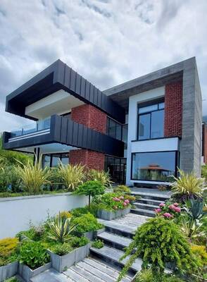 Modern contrasting facade with a combination of black panels, concrete, and terracotta brick