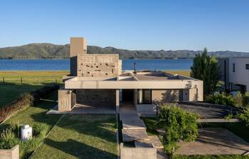 Minimalist lakeside house facade: concrete and geometry in harmony with nature