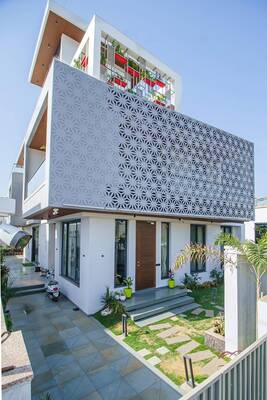 Modern house with perforated façade and multi-layered composition