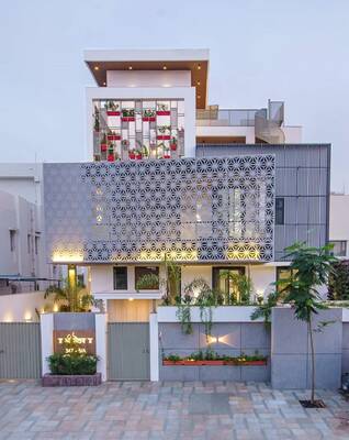 Modern urban house with perforated façade and vertical landscaping