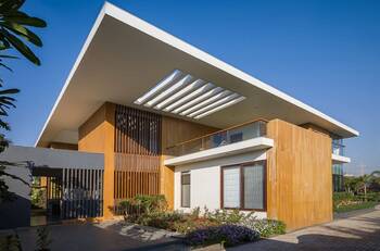 Modern two-story house with wooden facade and floating flat roof