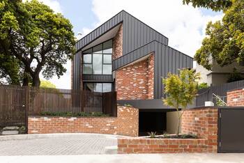 Modern House with Contrasting Brick and Metal Facade