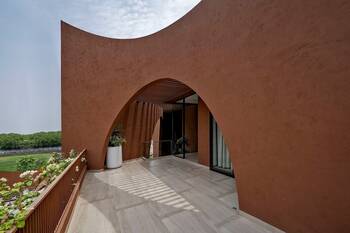 Organic Terracotta Facade with Arched Terrace