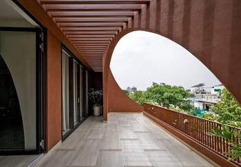 Organic facade with arch cutout: terracotta terrace with panoramic view